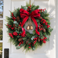 Christmas wreath with red velvet bow and antique gold bells on a white door